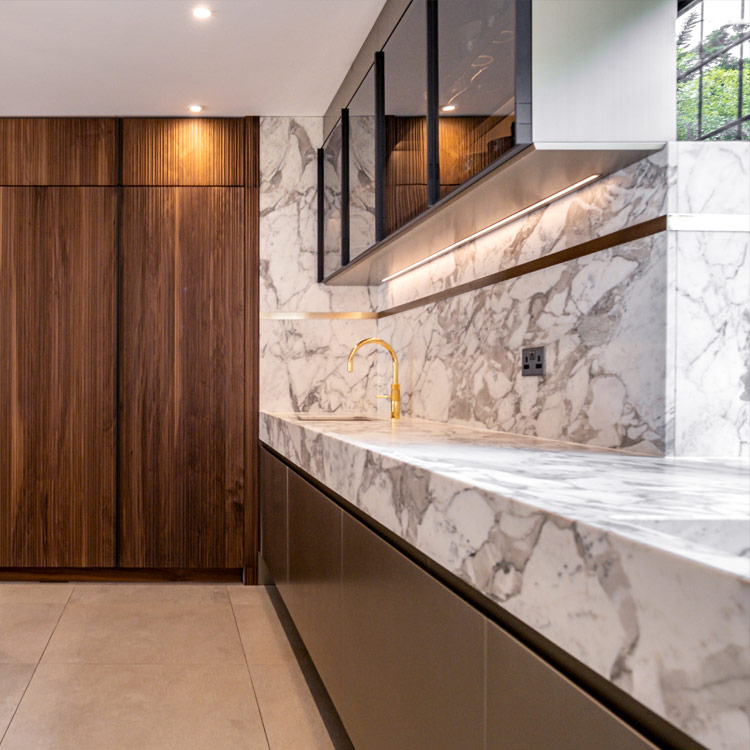 Full height cabinetry in a warm walnut canaletto is the perfect balance with the Italian marble worksurfaces | Fontana journal